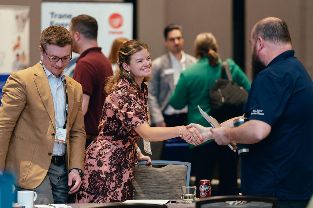 A buyer and supplier shake hands at the SED Forum