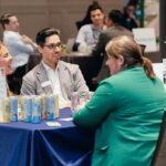 People engage in one-to-one meetings at SED Forum