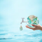 A water droplet falls from a globe to represent water conservation
