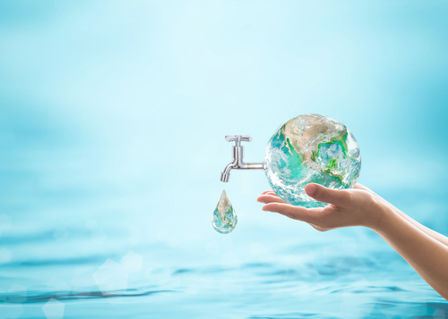 A water droplet falls from a globe to represent water conservation